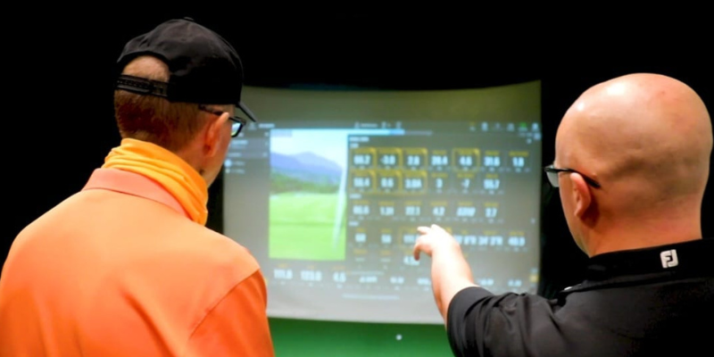 A lesson happening at indoor golf simulator, Golfontrack